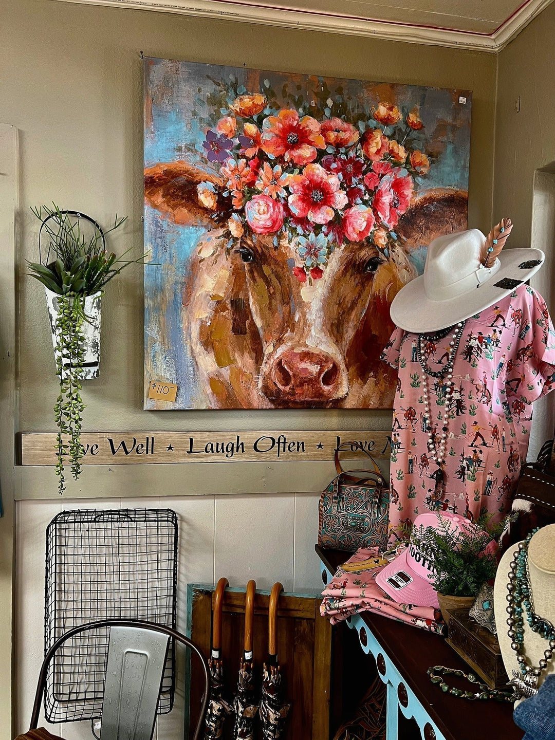 Cow floral canvas painting, pink western dress, and white cowboy hat unique display