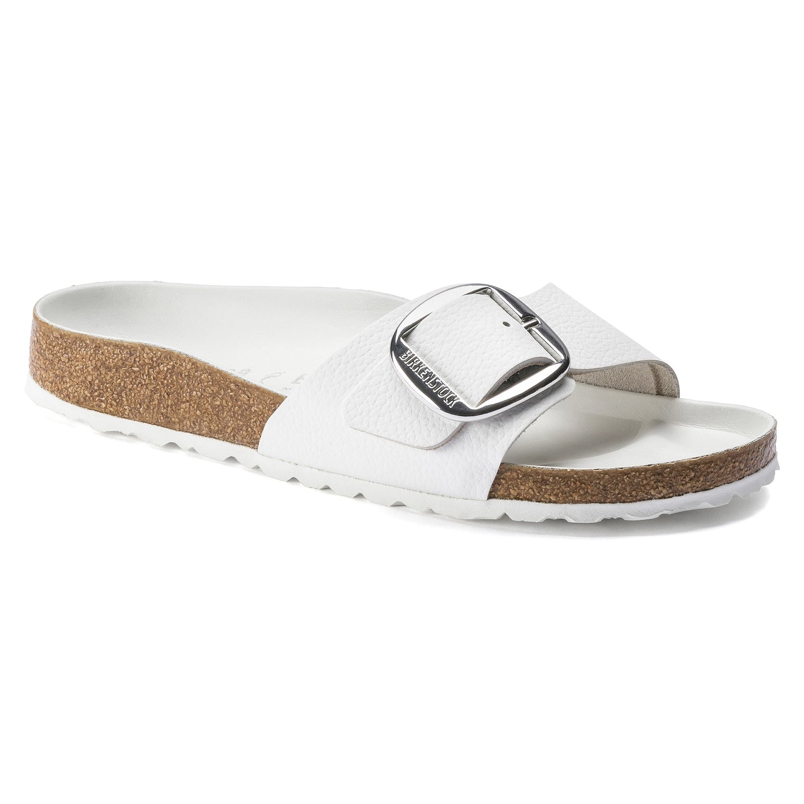 The Zertz MADRID BB WHITE LTR N 1018866 is a white slide sandal with a wide strap, large silver buckle, cork footbed, and textured tread. Its stylish design and comfortable white sole make it ideal for everyday wear.