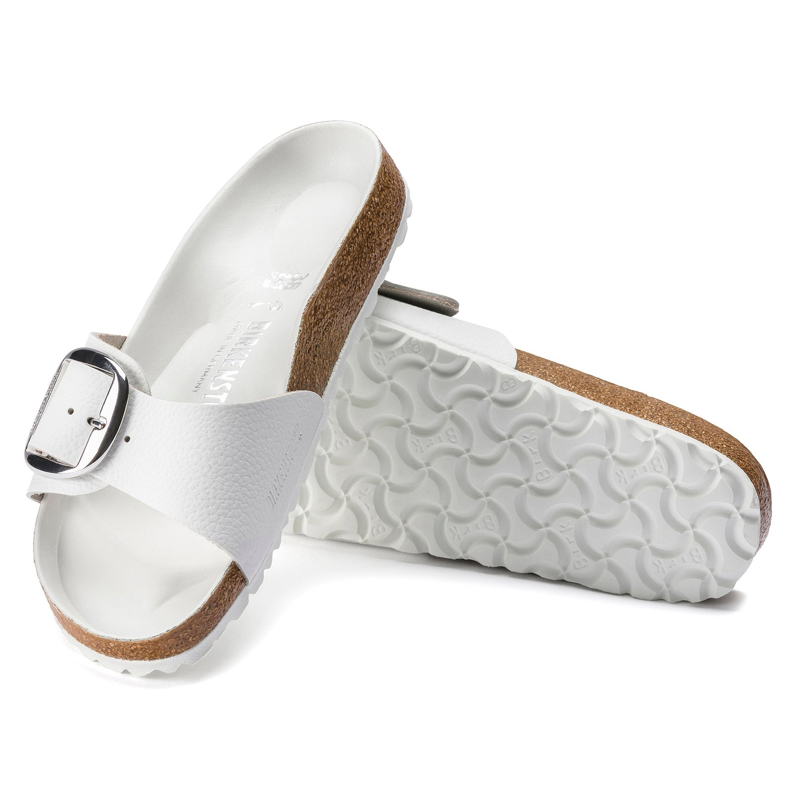 The Zertz MADRID BB WHITE LTR N 1018866 sandals feature white uppers, cork footbeds, adjustable silver buckle straps, and textured slip-resistant rubber soles. One sandal stands upright; the other is on its side to display the sole.