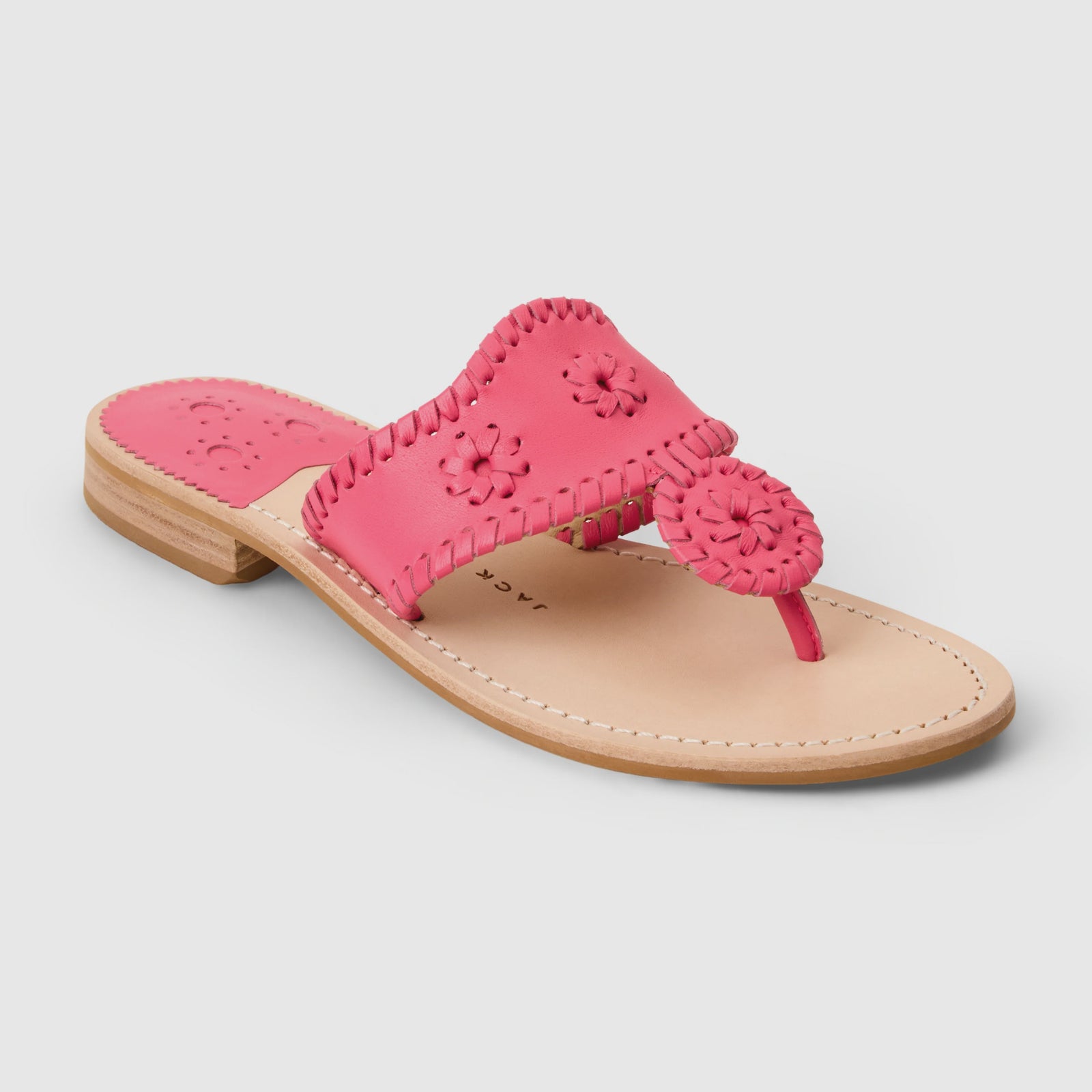 The Zertz JACKS FLAT SANDAL NAPPA is a pink leather sandal featuring a flat tan sole, open toe, decorative stitching, and floral cutout patterns on the strap and upper for added flexibility and stylish appeal.