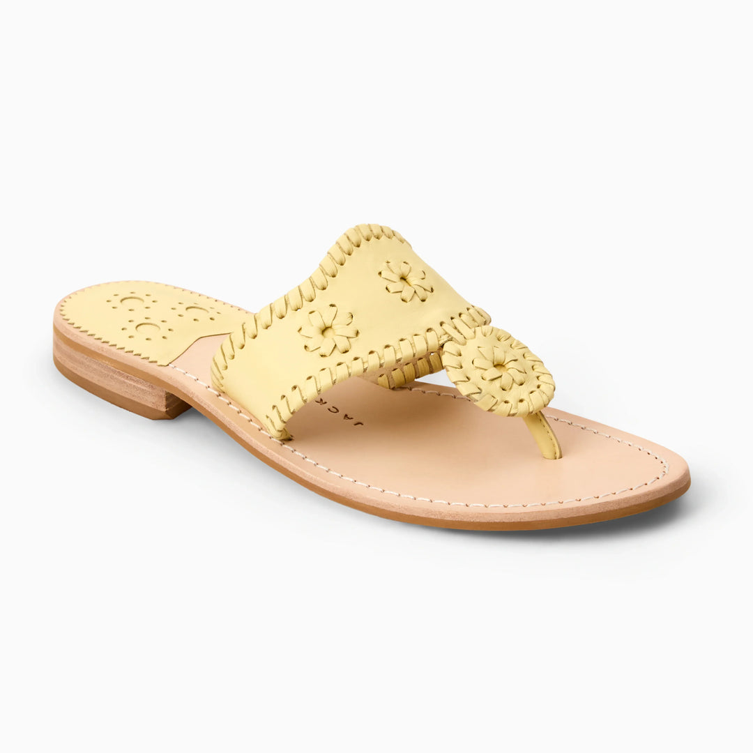 The Zertz JACKS FLAT SANDAL NAPPA is a yellow leather sandal with decorative stitching, a circular woven strap accent, and a flat light tan sole for flexible, all-day comfort.