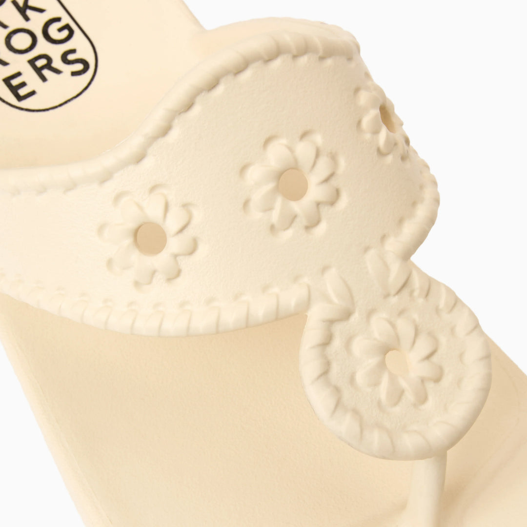 Close-up of the Zertz JACKS EVA sandal in cream, featuring ergonomic design, decorative cut-out flower patterns, stitched details, and branded insole visible in the corner.