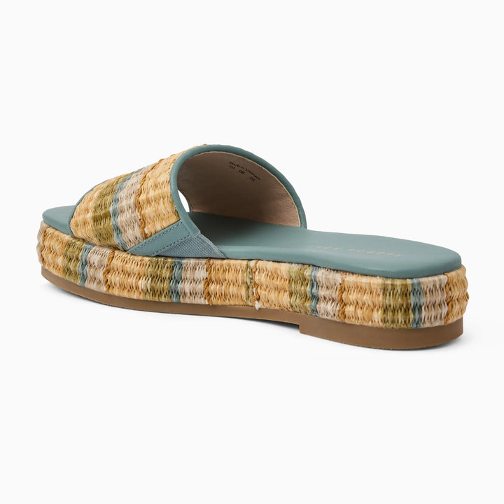 The Zertz BAY FLATFORM-RAFFIA sandal features a wide, multicolored straw strap, thick braided sole, teal footbed, and flat rubber bottom—perfect shoes for your next beach vacation.