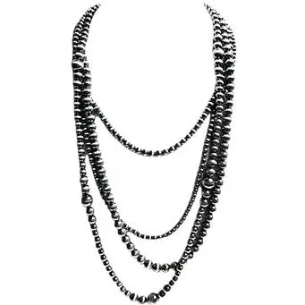 The Western Spirit Necklace by Loca on Main is a black and white image of a 4-strand design with assorted bead sizes, elegantly layered for a classic western Navajo pearl necklace style.