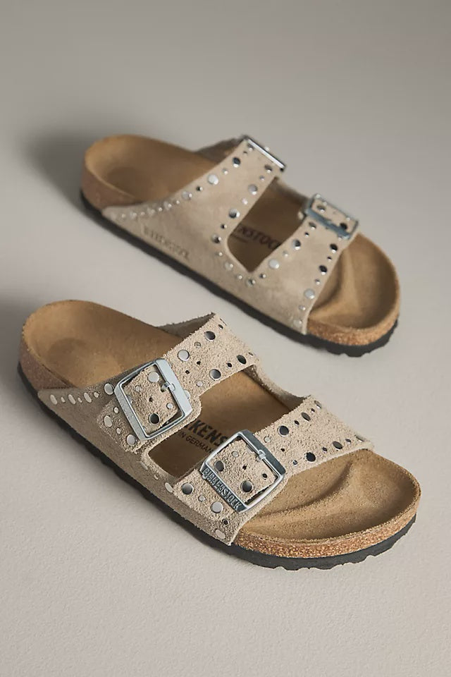 A pair of ARIZONA RIVET SUEDE TAUPE N sandals by Zertz, featuring taupe suede, two silver buckles, metallic studs, a contoured cork footbed, and black rubber soles.