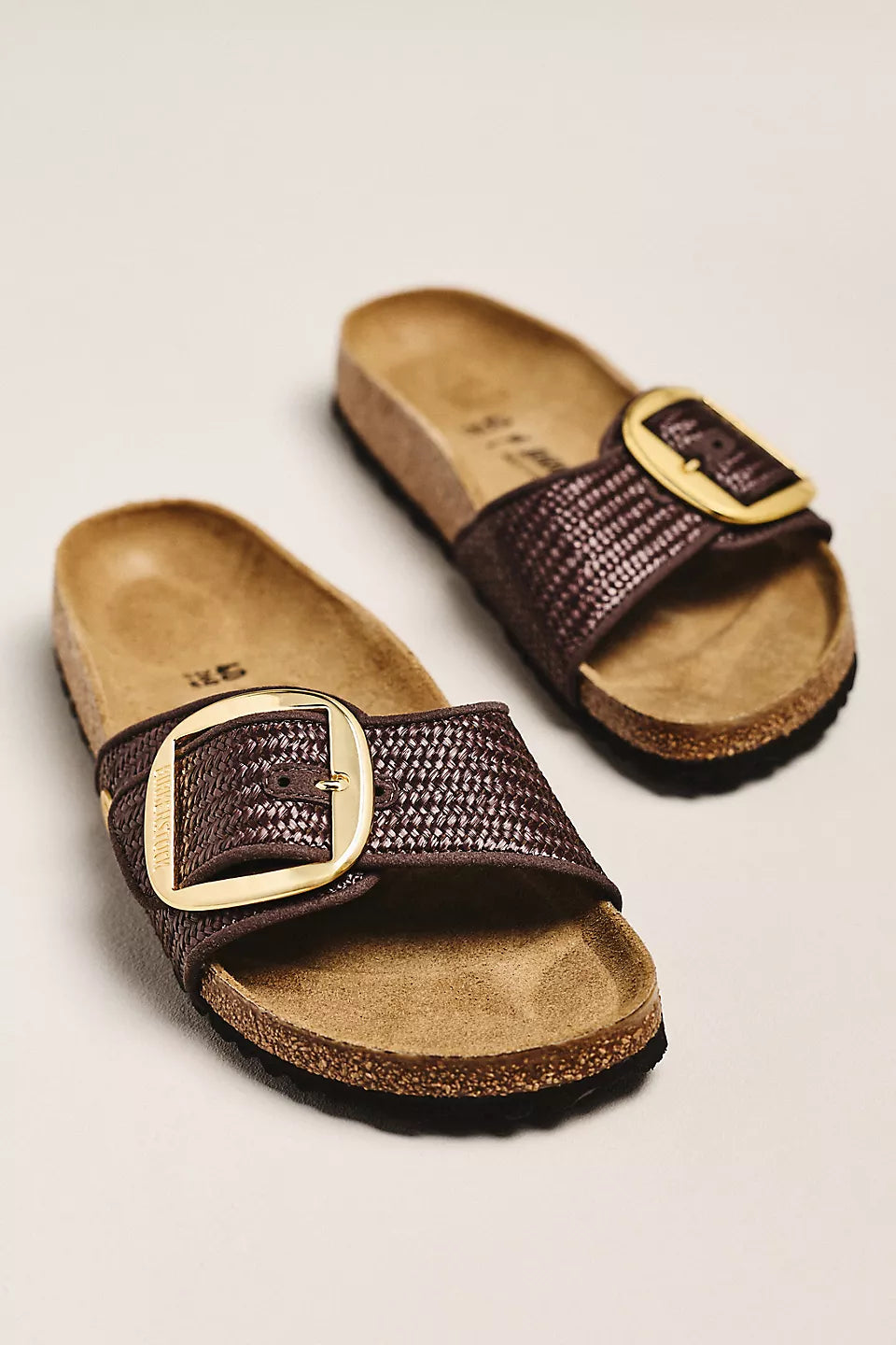 A pair of Zertz MADRID BIG BUCKLE TEX RAFFIA N brown slip-on sandals with textured straps, large gold buckles, and a contoured footbed, inspired by the classic Birkenstock Madrid, displayed on a plain light background.