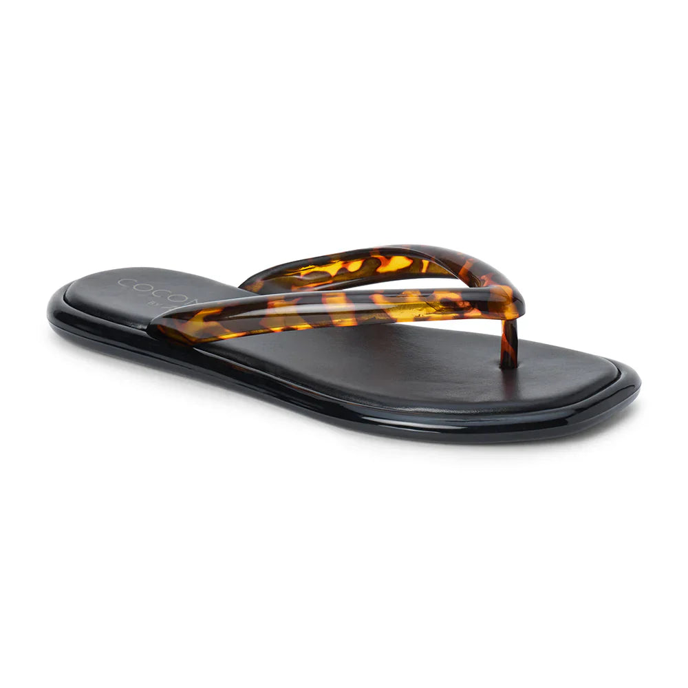 The Zertz MERMAID FLIP FLOP is a black sandal with glossy, thick tortoiseshell-patterned straps and a stylish tortoiseshell finish, crafted from vegan PVC, shown on a white background.