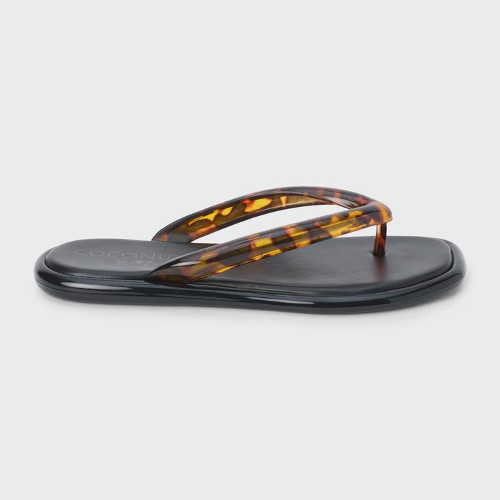 The Zertz MERMAID FLIP FLOP is a black vegan PVC sandal with a flat sole and tortoiseshell-patterned translucent thong straps, shown against a plain white background.
