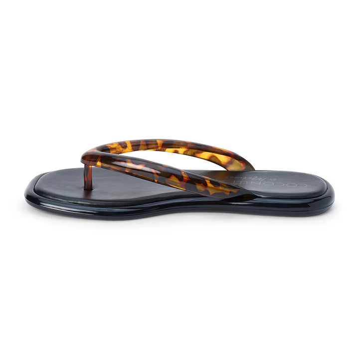 The Zertz MERMAID FLIP FLOP features a glossy black vegan PVC sole and brown tortoiseshell-finish straps, shown solo against a white background.