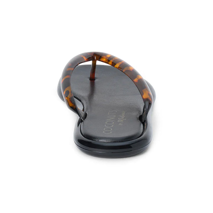 A close-up rear view of a black vegan PVC MERMAID FLIP FLOP by Zertz, featuring brown tortoiseshell-patterned straps and a chic tortoiseshell finish, with the brand name printed on the footbed.