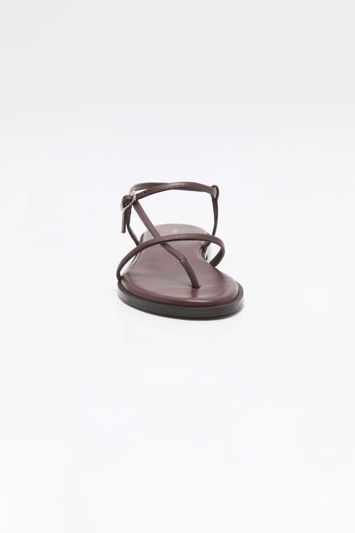 A single Zertz CORSICA STRAPPY SANDAL in brown, featuring thin straps and a toe loop, is displayed front-facing on a plain white background. This comfortable sandal offers effortless style.