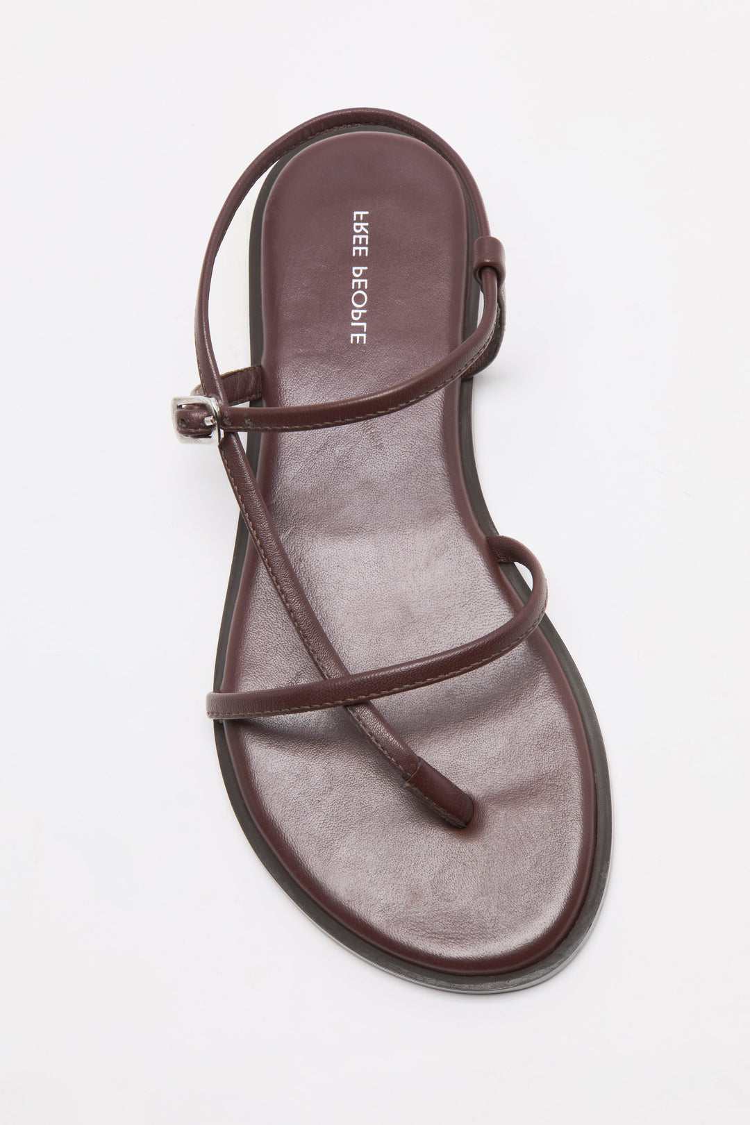A single flat brown CORSICA STRAPPY SANDAL by Zertz, featuring thin crisscross straps and an ankle strap, displayed on a white background—an ideal pick for stylish comfort.