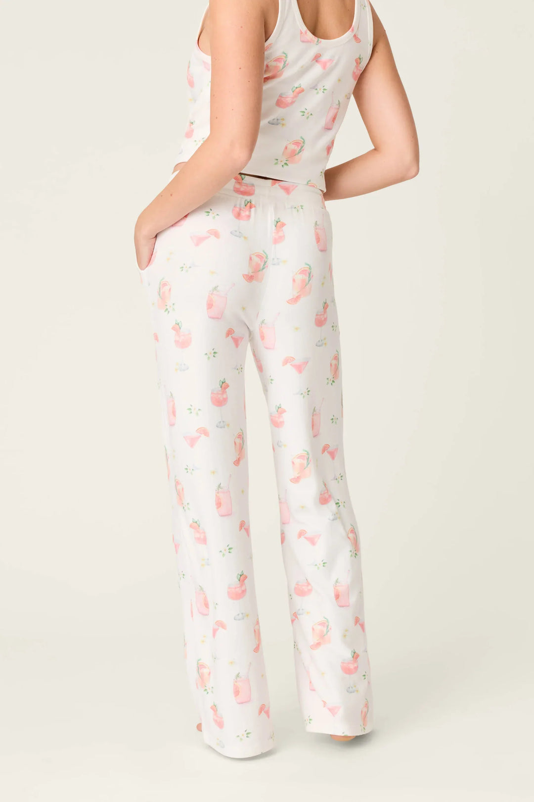 Someone stands with their back to the camera, one hand in a pocket, wearing Zertz&