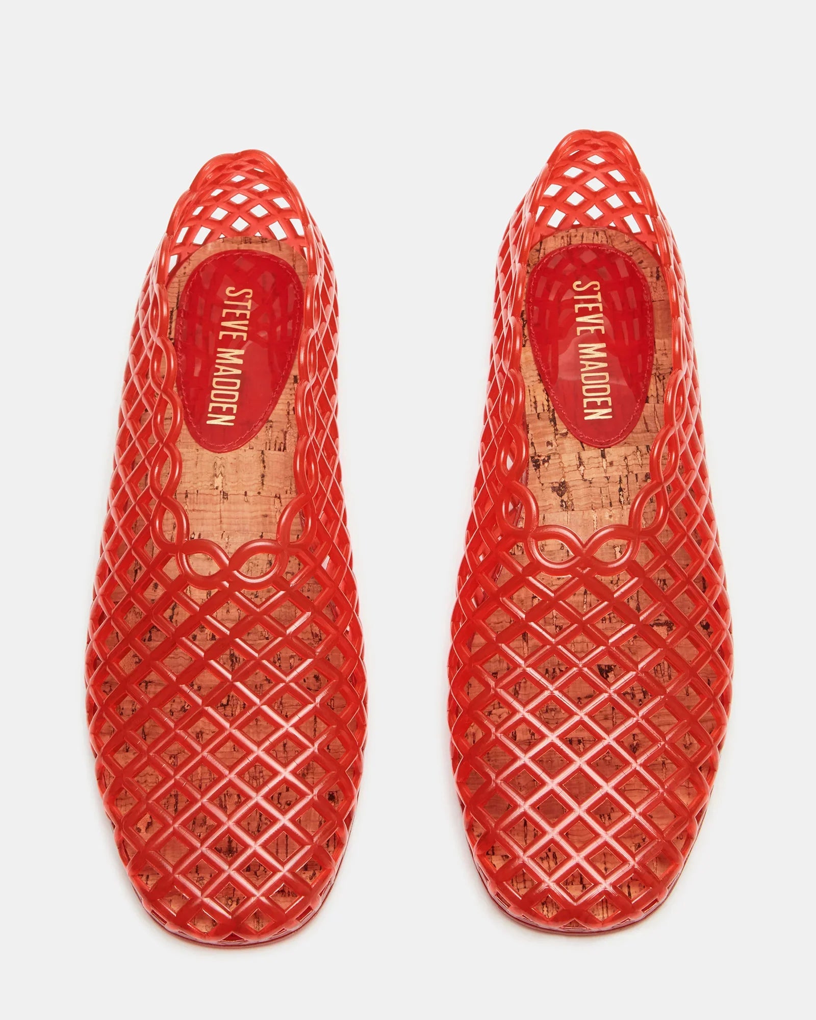 A pair of red GROVE JELLY SLIP ON shoes by Zertz with a lattice jelly cage design and cork insoles featuring the brand logo, shown from above on a white background.
