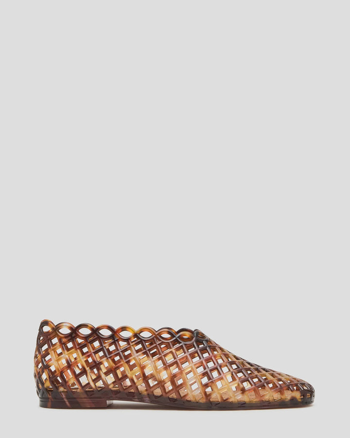 The Zertz GROVE JELLY SLIP ON is a brown, square-toe flat featuring a lattice-patterned, scalloped-edge design in see-through plastic jelly, ideal for everyday comfort and shown on a plain light background.