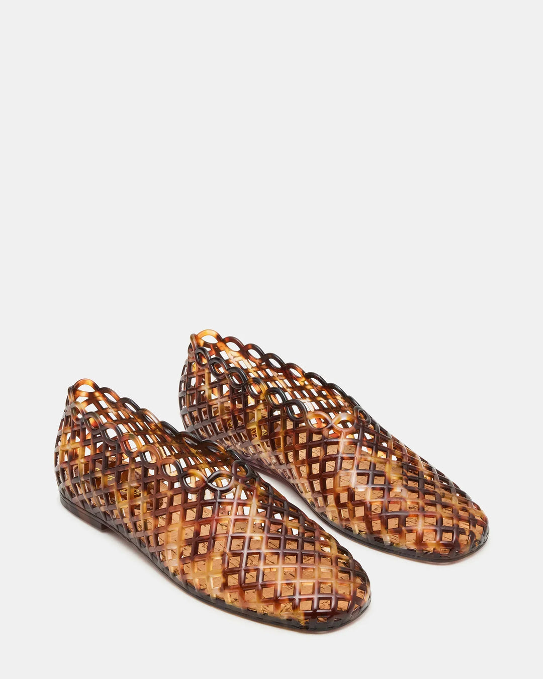 The Zertz GROVE JELLY SLIP ON is a pair of brown jelly shoes featuring a lattice cage design and closed toes, ideal for comfortable everyday wear, shown against a plain white background.