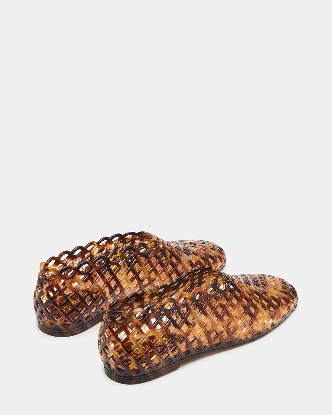 The Zertz GROVE JELLY SLIP ON is a pair of brown flat jelly shoes with a glossy, lattice-patterned square toe and cage design, shown from the rear against a white background.