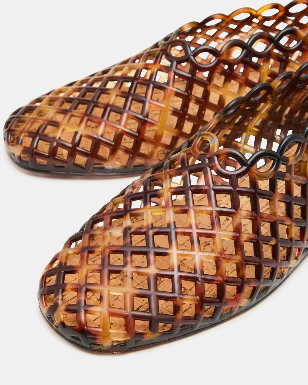 Close-up of Zertz GROVE JELLY SLIP ON: translucent brown, glossy square-toe flats with a lattice-patterned jelly cage design and intricate cut-outs—perfect for stylish, comfortable everyday wear.