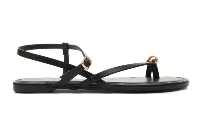 The Zertz TREASUREE STRAPY FLATS are women’s faux leather flats with thin criss-cross straps, an ankle buckle, and a gold metallic accent on the toe strap.