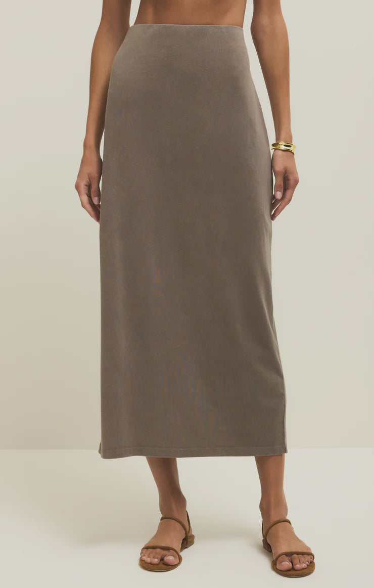 A woman wearing the Zertz GAIL MIDI SKIRT in Perfectly Taupe, featuring an elastic waistband.