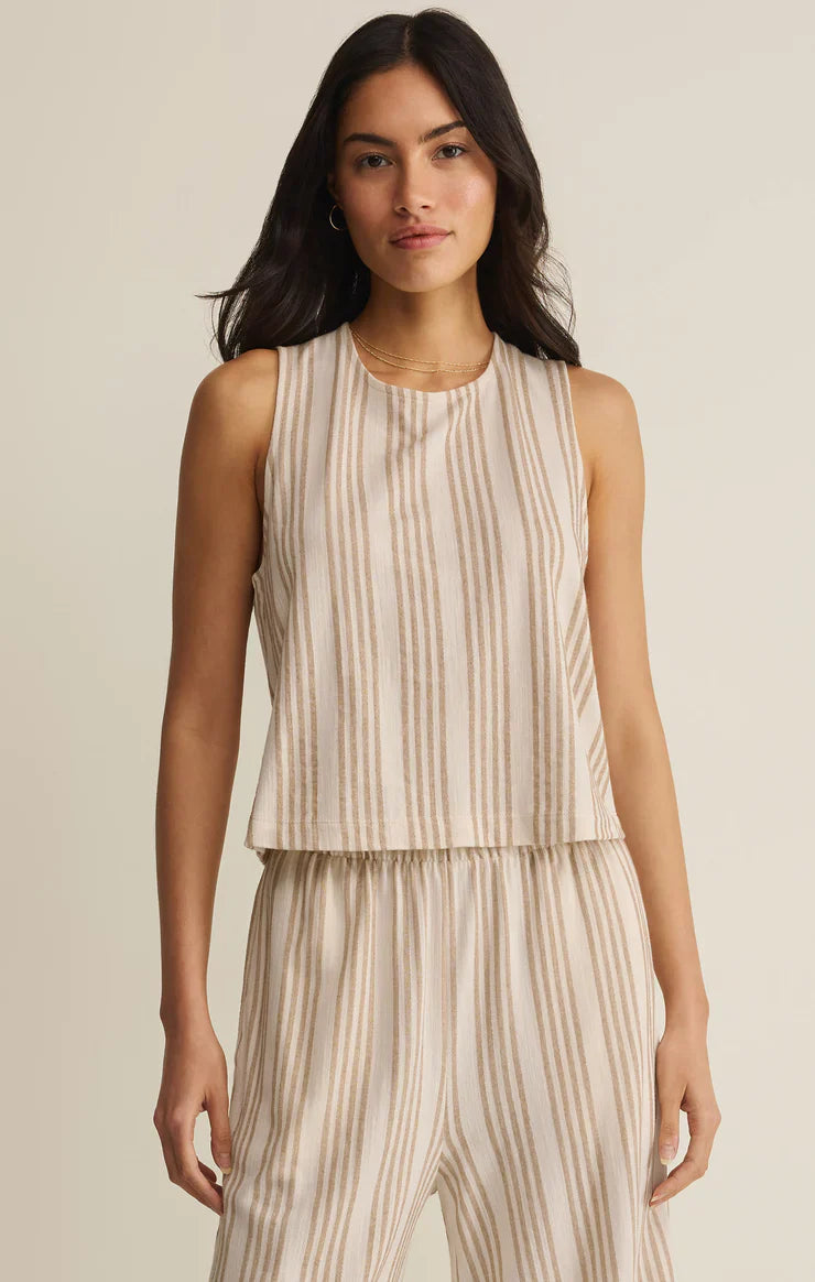A woman faces forward in the Zertz SLOANE KNIT STRIPED TOP, a sleeveless beige cotton-blend with vertical tan stripes and a relaxed fit. She&