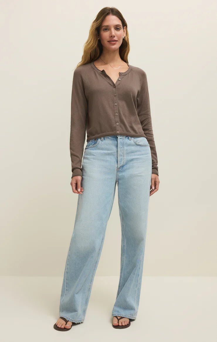 A woman stands against a plain light background wearing Zertz&
