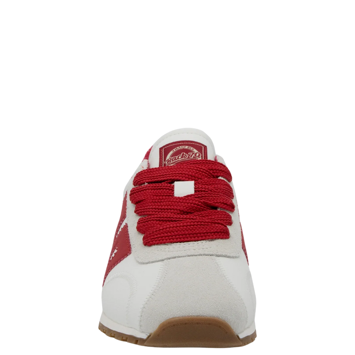 The Zertz ASIAN RED SNEAKER is a red and white fashion sneaker with sporty red laces, a suede toe cap, and a brown rubber sole, shown from the front against a plain white background.