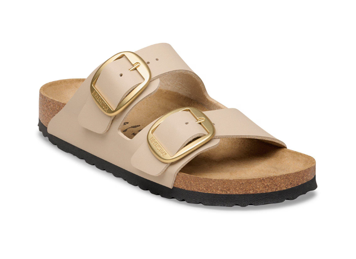 The Zertz ARIZONA BIG BUCKLE SANDCASTLE sandal features two wide beige Birko-Flor straps with large gold buckles, a cork footbed, and a black textured sole.