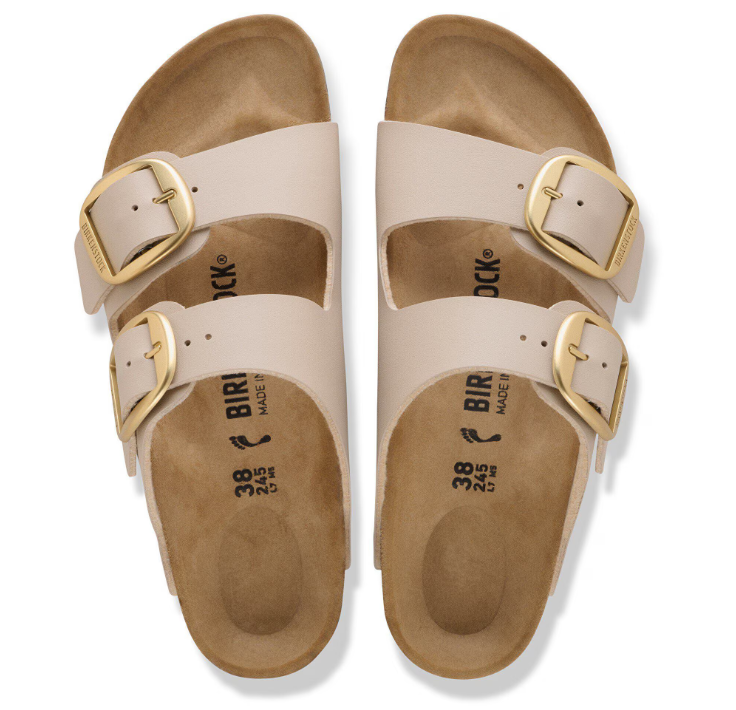 A pair of sandcastle beige Zertz ARIZONA BIG BUCKLE sandals with two wide straps, large gold buckles, contoured cork footbeds, Birko-Flor uppers, and black insole branding.