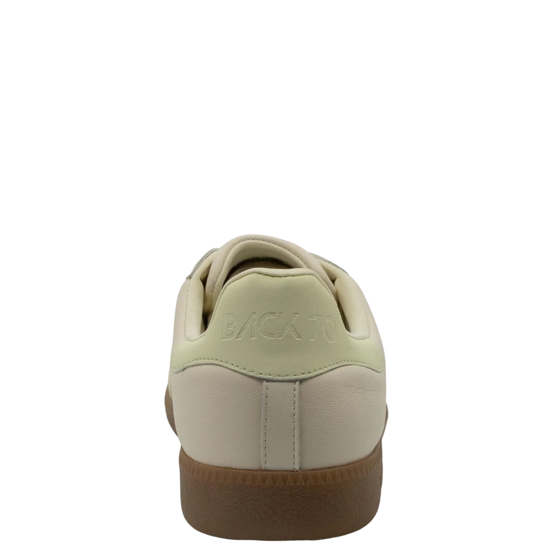 The Zertz CLOUD D26 BUTTER YELLOW SNEAKER for women features a beige pastel look, light green heel accent, "BACK TO" embossed on the heel tab, and a brown rubber sole—ideal for minimalist luxe streetwear.