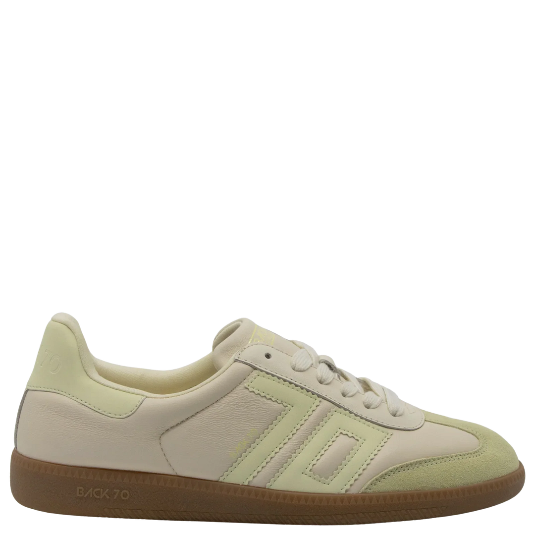 The Zertz CLOUD D26 BUTTER YELLOW SNEAKER features cream and light green pastel hues, white laces, textured panels, and a light brown rubber sole—perfect for luxe streetwear, shown in side profile on a plain white background.