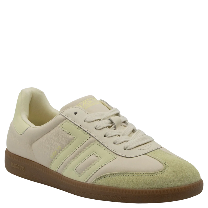 The Zertz CLOUD D26 BUTTER YELLOW SNEAKER features beige and light yellow pastels, a suede toe, leather panels, and a brown rubber sole—stylishly captured at an angle on a white background, perfect for luxe streetwear.