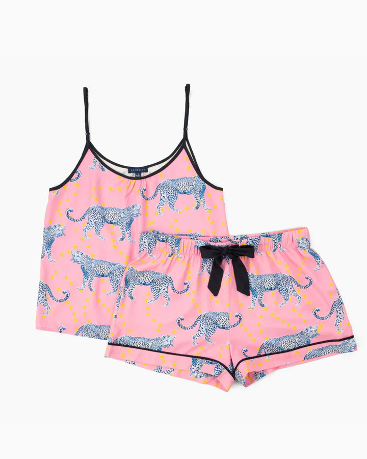The Zertz COSMIC CHEETAH CAMI SHORTS SET includes a chic pink cami top with adjustable straps and matching shorts, detailed with blue leopard spots, yellow stars, black trim, and a cute black bow at the waistband.