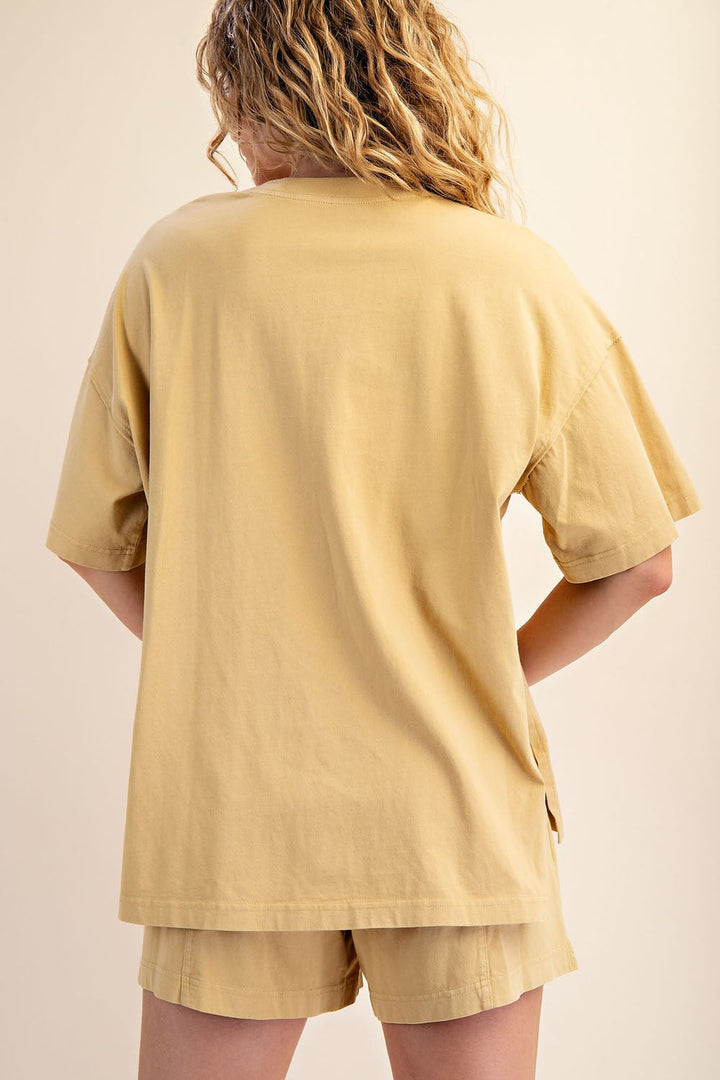 A person with wavy, shoulder-length hair is seen from behind wearing Loca on Main&