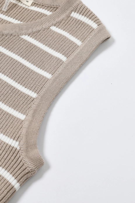 Close-up of the Zertz LUCIENNE KNIT MIDI DRESS, a beige sleeveless design with white horizontal stripes and ribbed edges at the armholes and neckline, laid flat on a white surface.