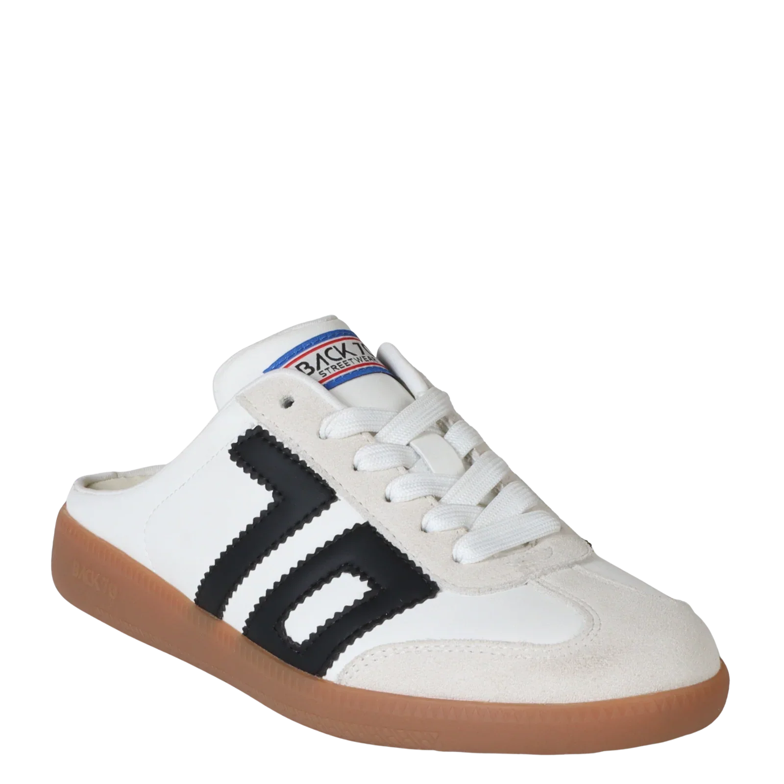 The Zertz EASTER IN BLACK WHITE SNEAKER is a women's white slip-on with a gum rubber sole, black zigzag stripes, white laces, and a blue-red-white "Backyard" logo on the tongue for streetwear style.
