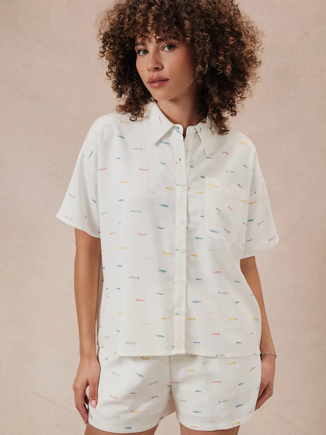 A woman with curly hair wears Zertz&