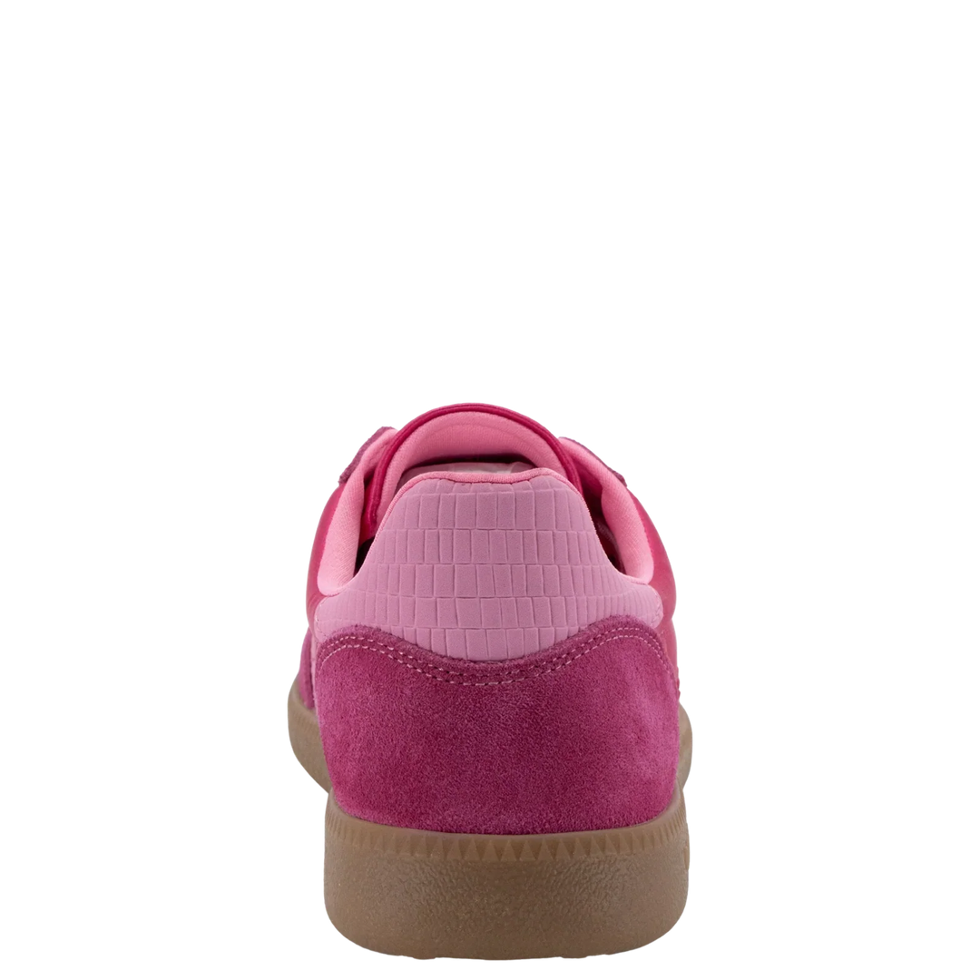 The Zertz GHOST C26 IN FUXIA SNEAKER features a pink suede handcrafted design, a textured light pink heel panel, and a brown rubber sole for a casual sporty style, shown from the rear against a plain white background.
