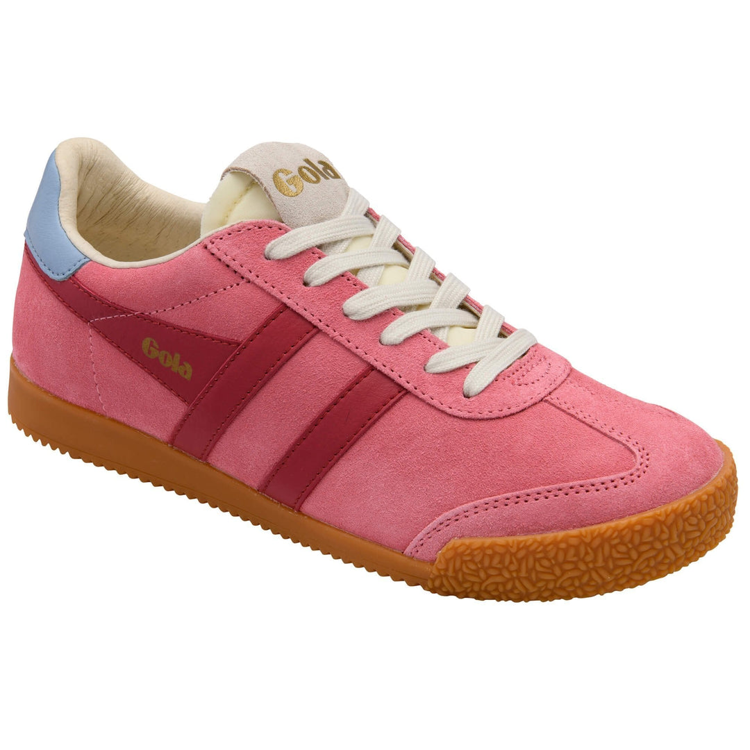 The Zertz ELAN TRAINER is a pink suede women’s sneaker with red stripes, tan sole, white laces, light blue heel detail, and gold branding—an iconic heritage sports shoe with timeless style.
