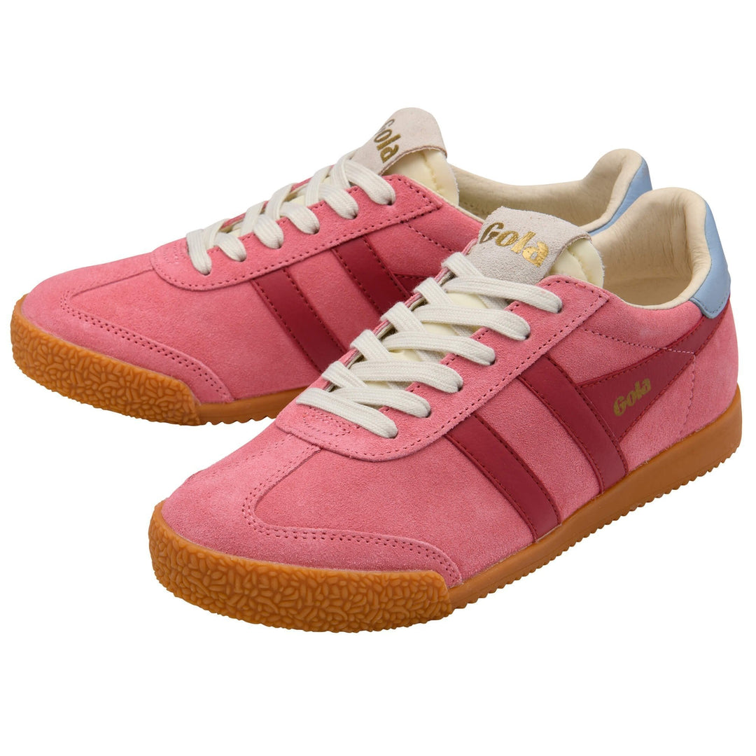 The Zertz ELAN TRAINER is a pair of pink suede women’s sneakers with red stripes, white laces, gold Zertz branding, light blue heel accents, and textured gum soles—a heritage classic reinvented for modern style.