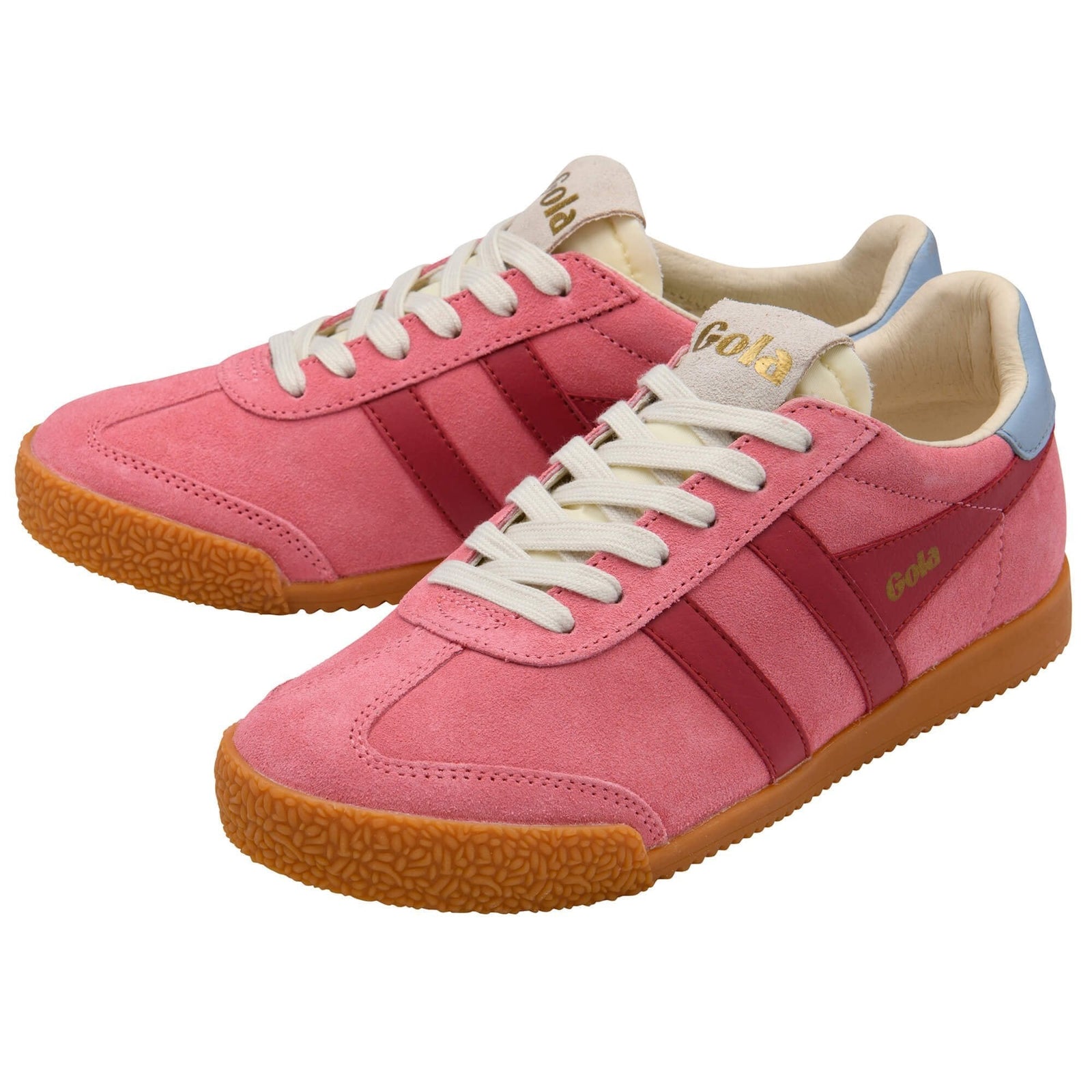 The Zertz ELAN TRAINER is a pair of pink suede women’s sneakers with red stripes, white laces, gold Zertz branding, light blue heel accents, and textured gum soles—a heritage classic reinvented for modern style.