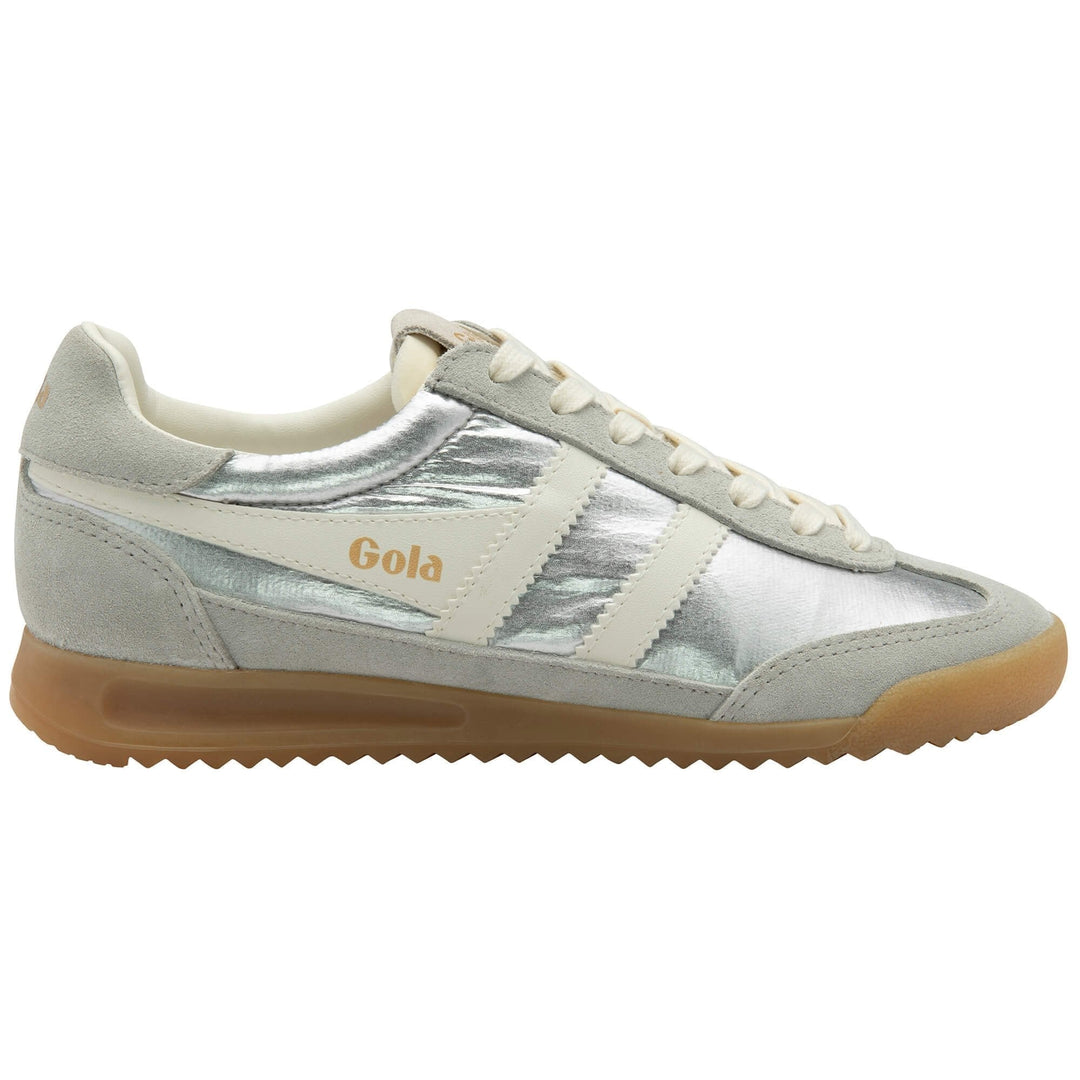 The Zertz FIREFLY METALLIC TRAINER CLB858JW208 is a silver and white sneaker featuring suede accents, cream laces, and a gum rubber sole, shown from the side.