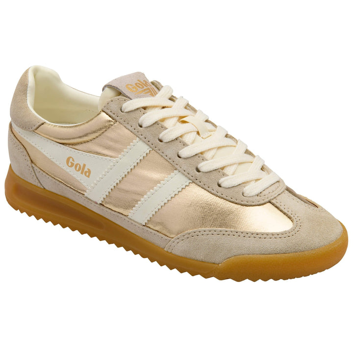 The Zertz FIREFLY NETALLIC TRAINER CLB858YW20 is a gold and beige sneaker with white stripes, beige suede accents, white laces, and a brown textured rubber sole, shown from an angled top view.