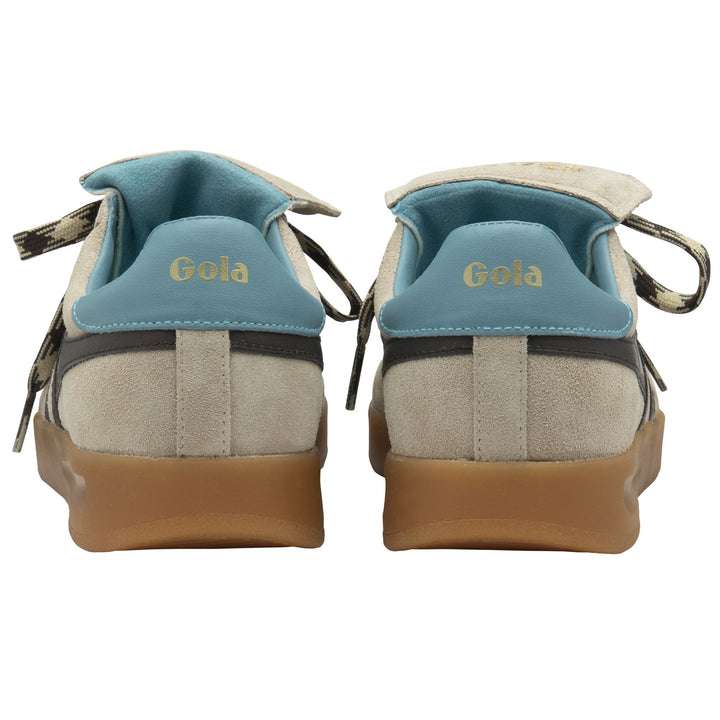 A rear view of Zertz STADIA 86 TRAINER sneakers in bone/mocha/ocean with blue heel tabs, gold branding, gum soles, and patterned laces at the sides that evoke a vintage football silhouette.