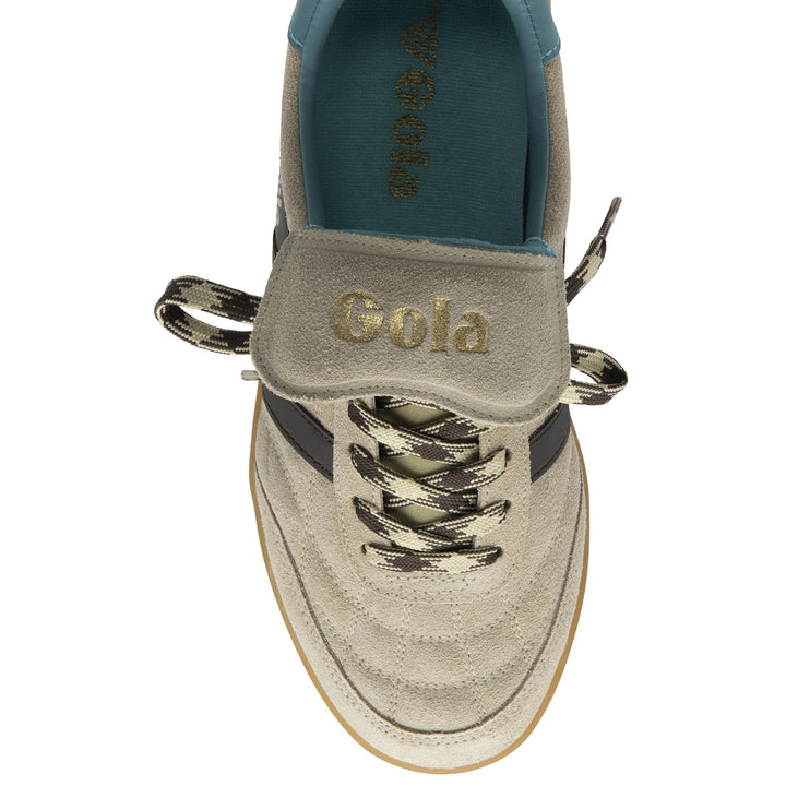 Top view of the Zertz STADIA 86 TRAINER in Bone/Mocha/Ocean/Gum, displaying a vintage football-inspired silhouette, beige upper with gold branding on the tongue, black and beige zigzag laces, teal insole, and gum-colored sole.