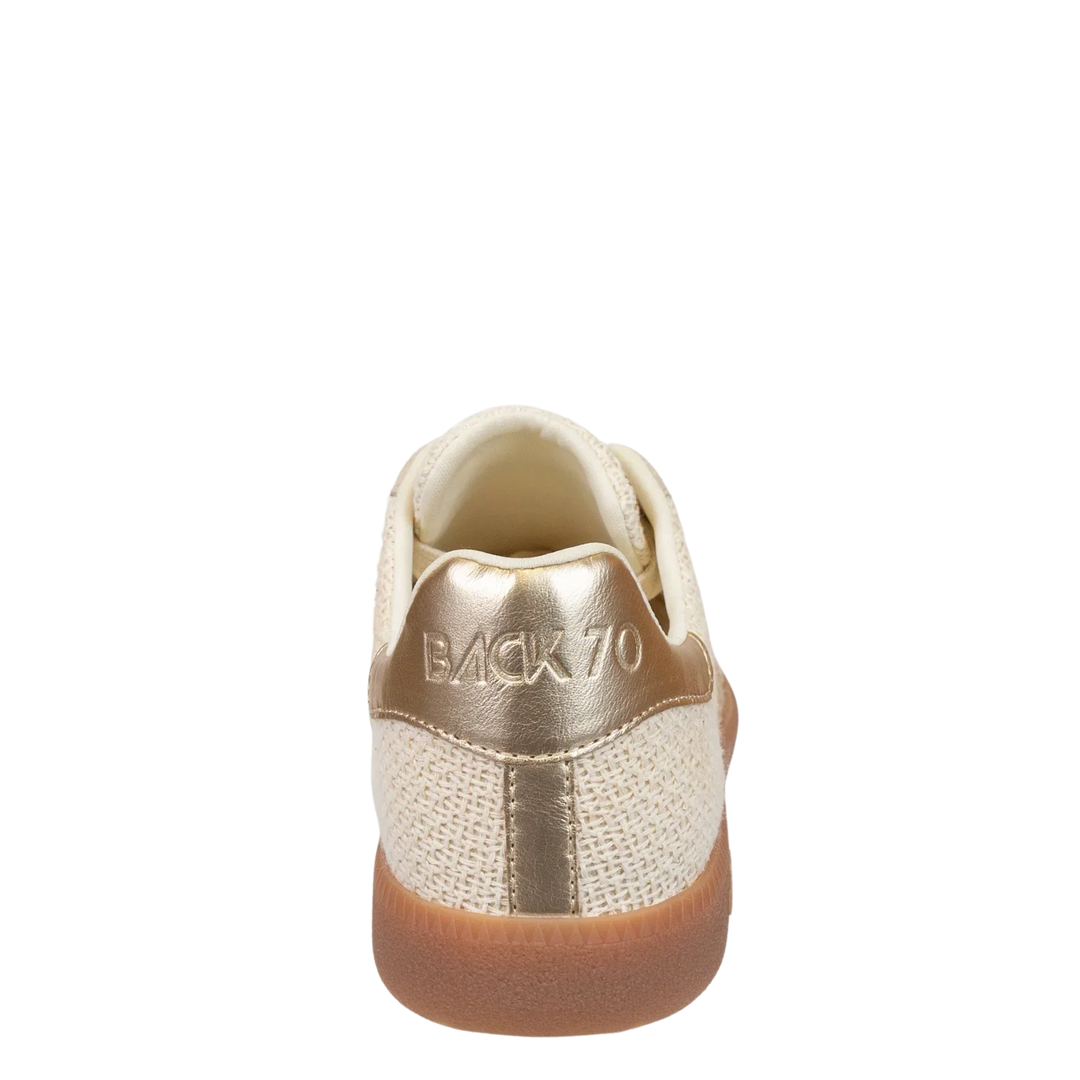 The Zertz IUTA 2512 GOLD SNEAKER is a beige and gold soccer-inspired shoe with "BACK 70" on the metallic gold heel, a woven upper, and a brown rubber sole, shown from the back.
