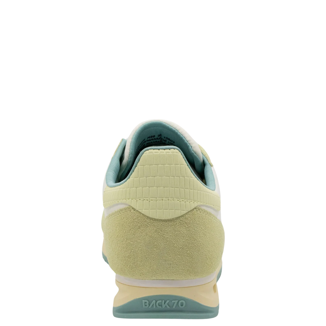 The JOGGER N26 sneakers by Zertz in pastel yellow and light green feature a suede heel, textured upper, and BACK 70 embossed above the heel—offering subtle sportswear luxury when viewed from the back.
