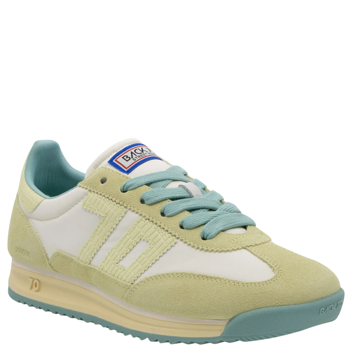 The Zertz JOGGER N26 in SNEAKERS showcases quiet luxury with pastel green suede, off-white panels, blue laces, a cream sole, blue-tinted lining, side stitching details, and a logo patch on the tongue.