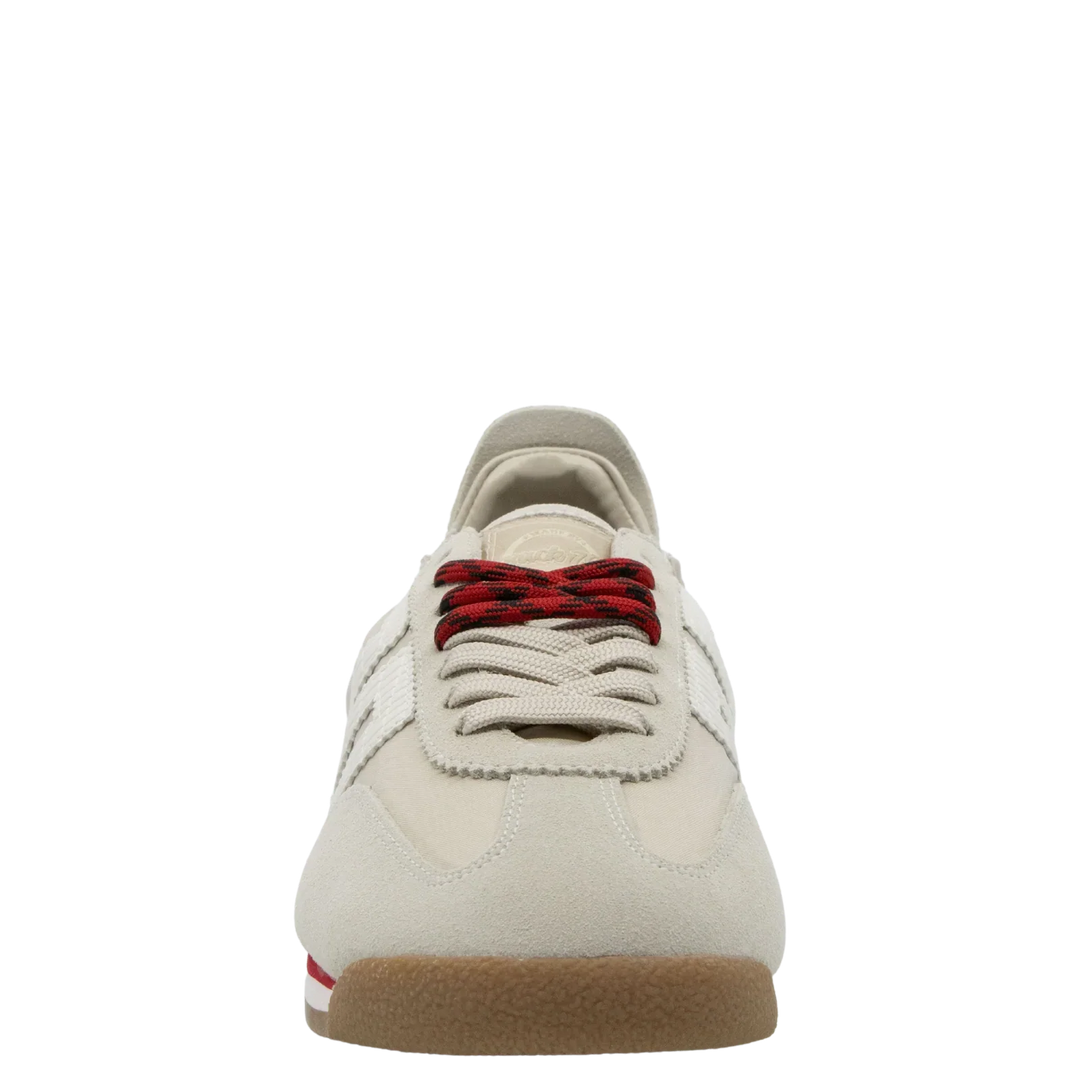 The Zertz ROCKET SAND SNEAKERS are light beige, running-inspired shoes with sporty red and black striped laces, white side stripes, and a gum sole featuring a small red accent for a casual style.
