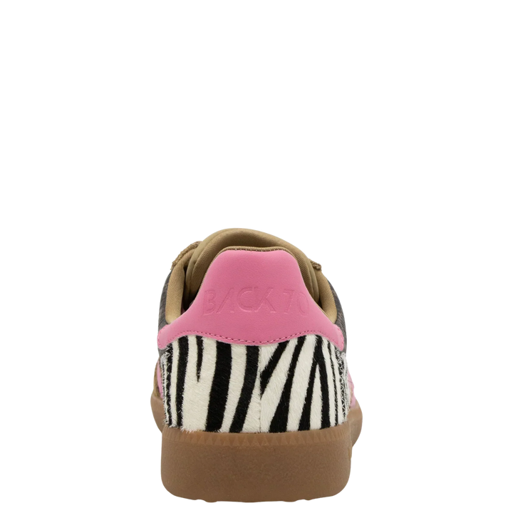The Zertz SQUID IN LEOPARD ZEBRA FUXIA SNEAKER showcases black and white zebra print, a fuchsia heel tab, tan lining, and a brown sole—a bold choice for unique animal print sneaker fans.
